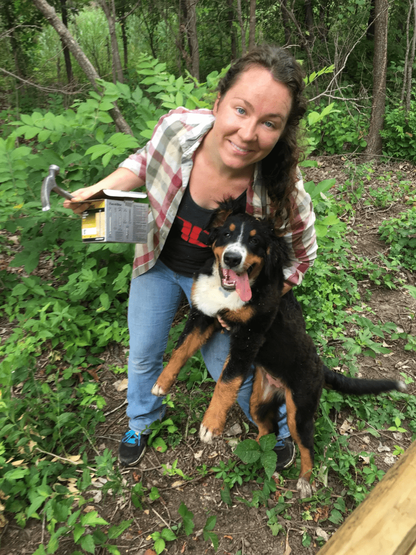 A woman and her dog in the woods